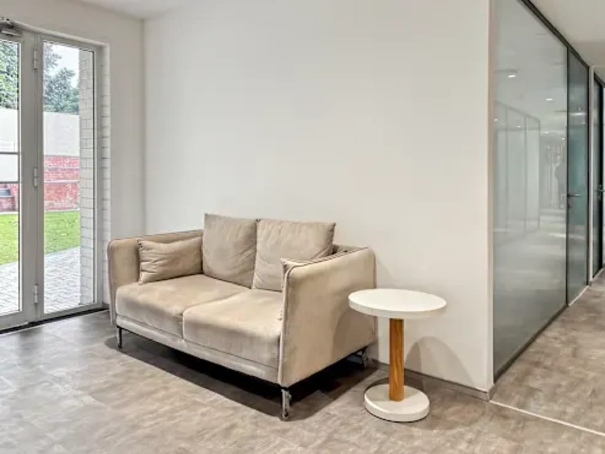 Cozy breakout area with natural light and comfortable seating in Sector 26 coworking space.