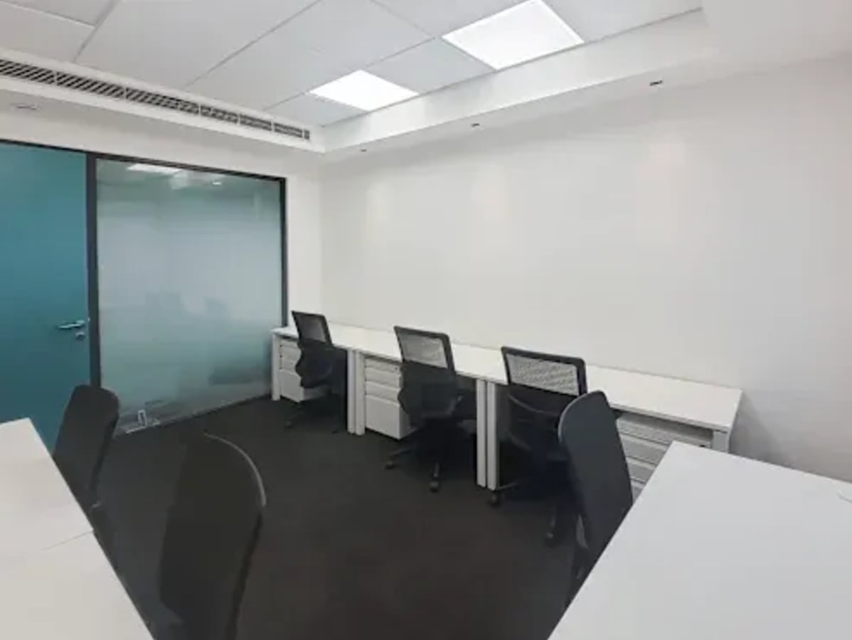 Modern coworking space with individual desks, ergonomic chairs, and bright lighting in Sector 26, Chandigarh.