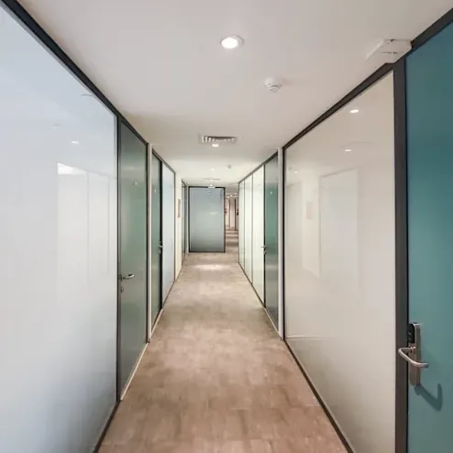 Modern coworking space with sleek glass partitions and ample natural light in Chandigarh.