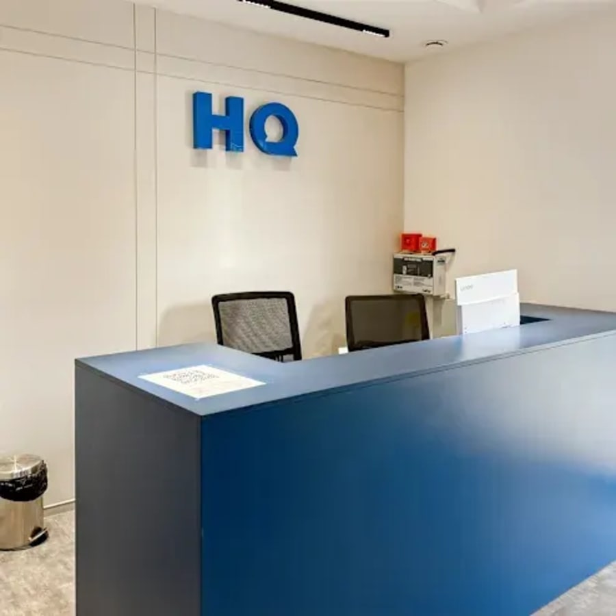Reception area in a modern coworking space, featuring sleek furnishings and ample lighting.