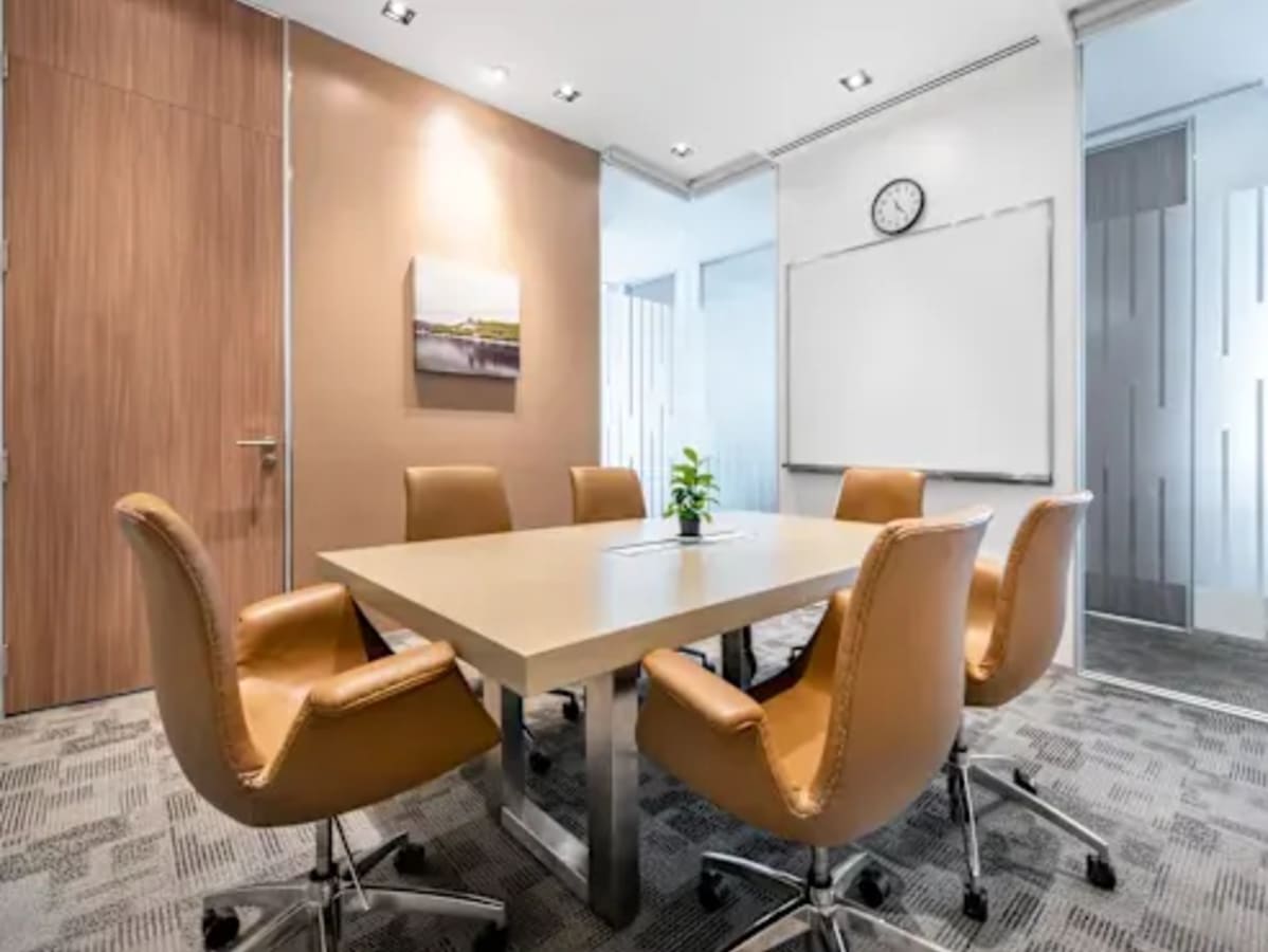 Modern meeting room with sleek chairs, ample lighting, and a collaborative ambiance. Perfect for teams.