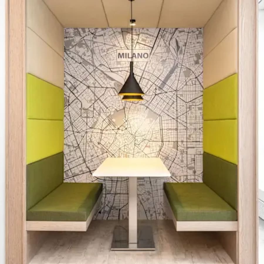 Modern meeting nook with map-themed decor and cozy booth seating in Sahar Road coworking space.