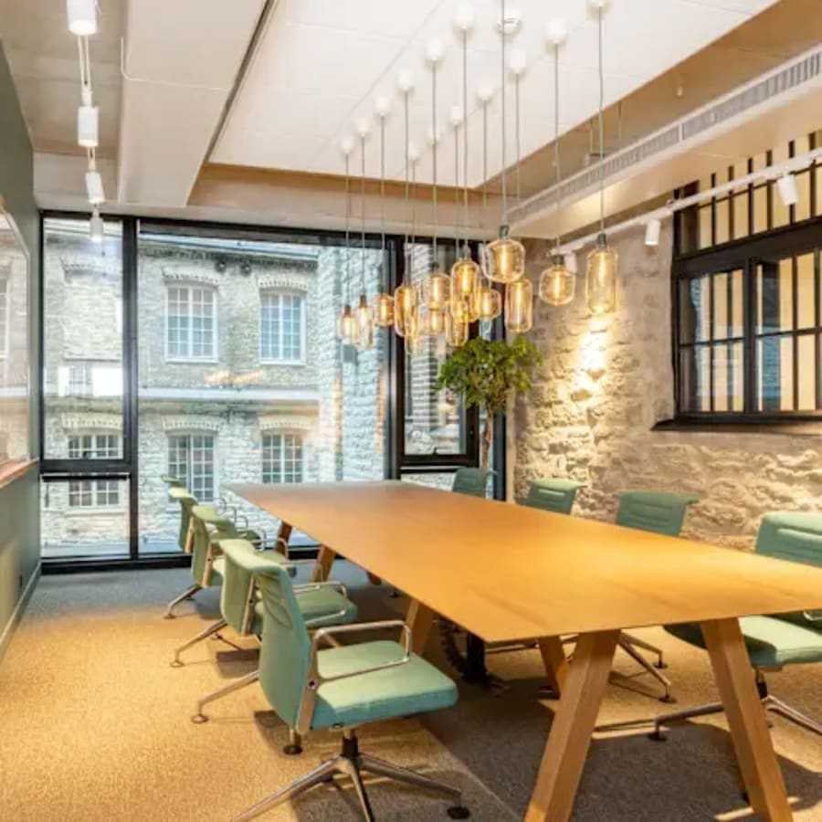 Modern coworking space on Mahatma Gandhi Road, featuring a spacious meeting room with stylish lighting and natural light.