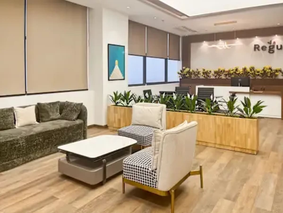 Stylish coworking space with modern seating, natural light, and elegant decor in Haryana.