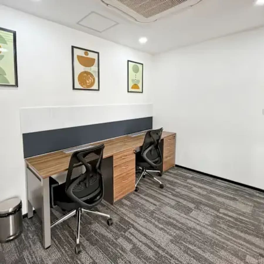 Modern coworking space with ergonomic chairs and individual workstations.