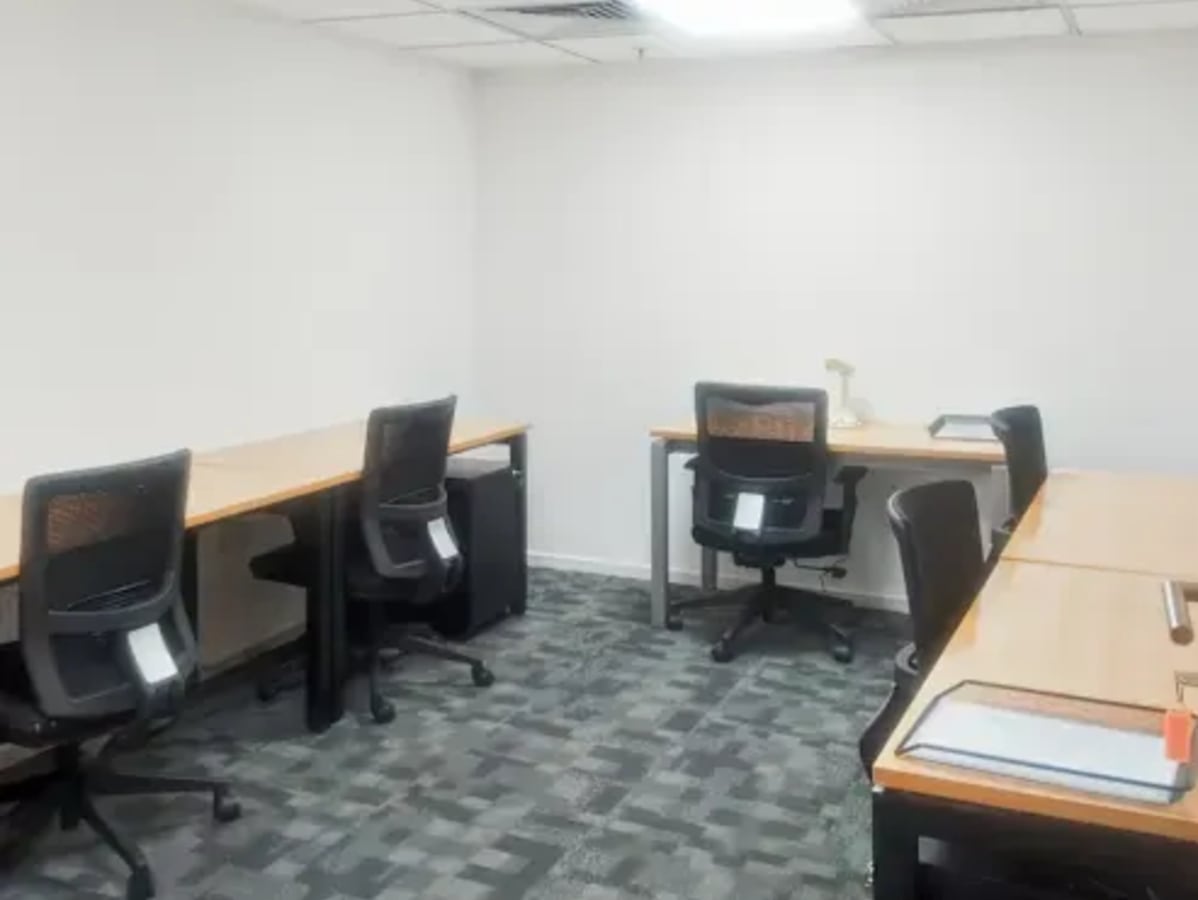 Modern coworking space with ergonomic chairs and spacious desks for productivity.