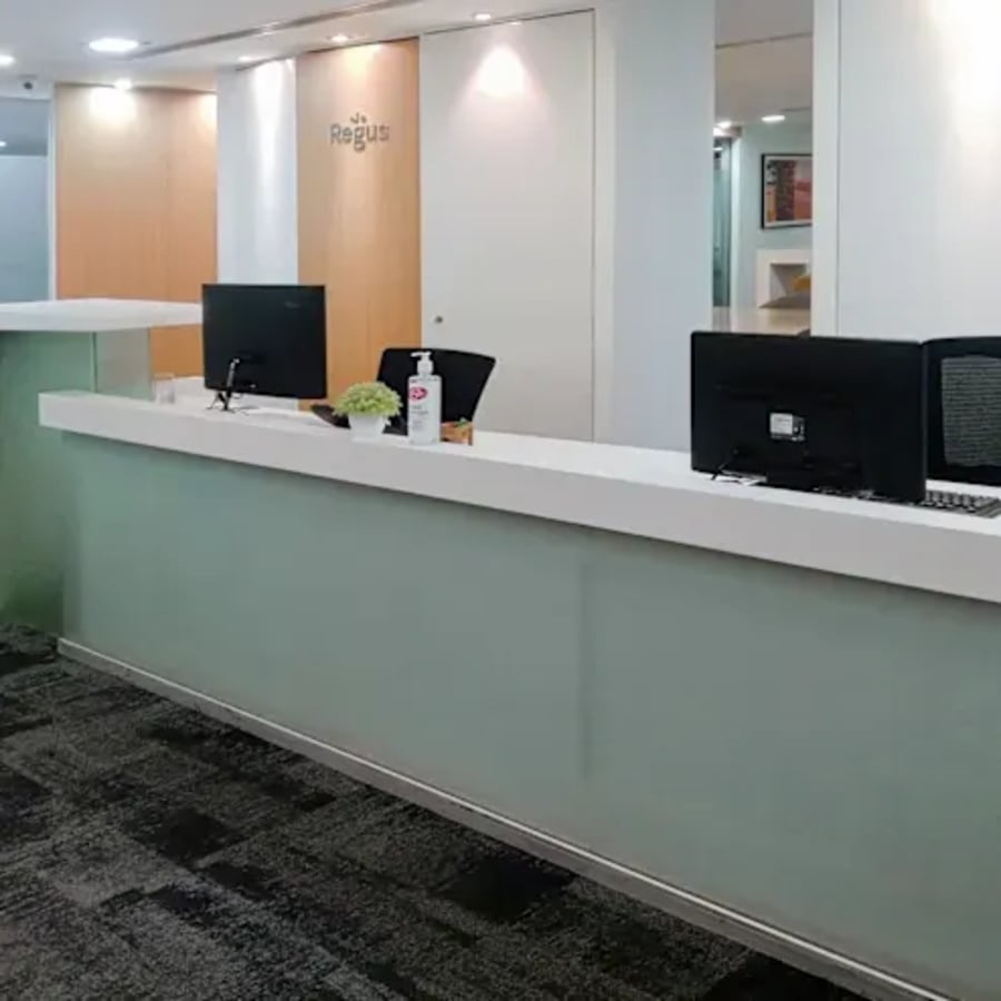 Modern reception area with sleek counters and ample lighting at a Tonk Road coworking space.