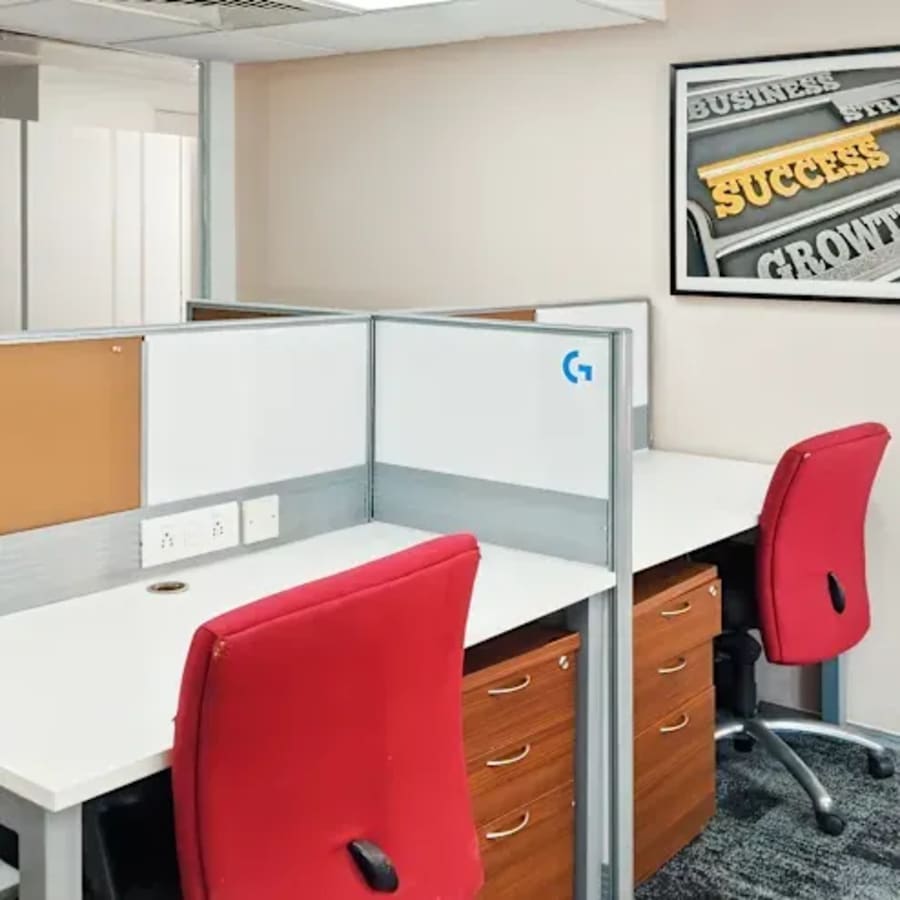 Modern coworking space with vibrant red chairs and motivational decor on Tonk Road.
