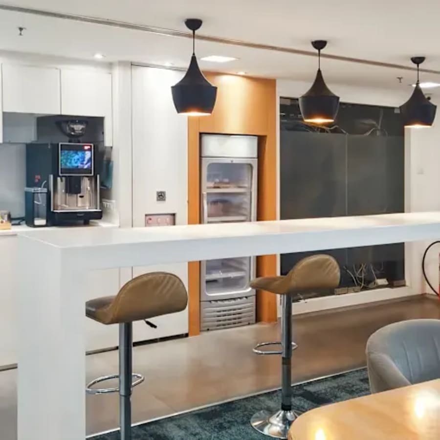 Modern coworking space with a sleek kitchenette and bar seating on Tonk Road, Rajasthan.