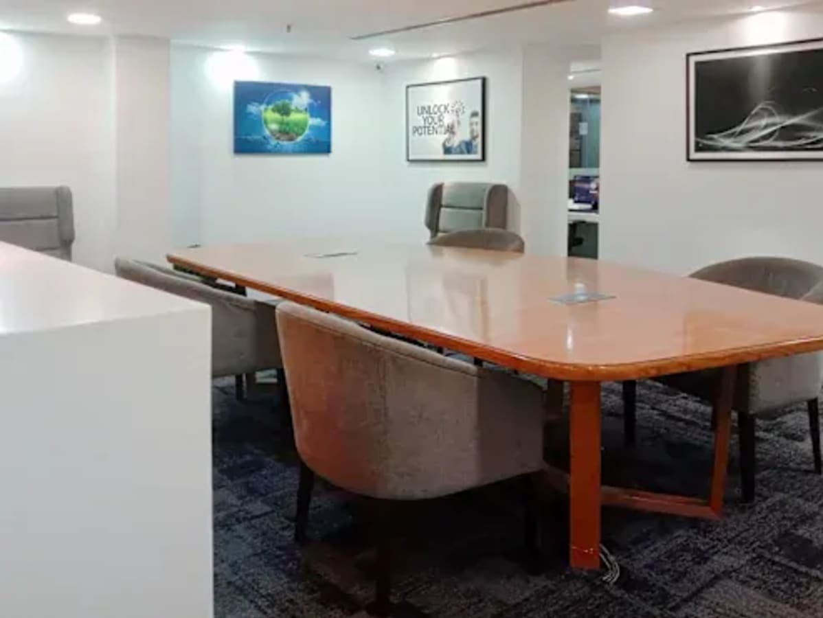 Spacious meeting room with modern art and sleek furnishings in a Tonk Road coworking space.