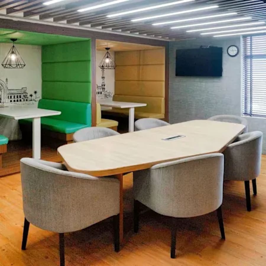 Modern coworking space with vibrant booths and sleek conference table in Gomti Nagar.