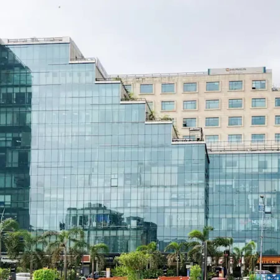 Modern coworking space in Gomti Nagar with sleek glass architecture and lush surroundings.