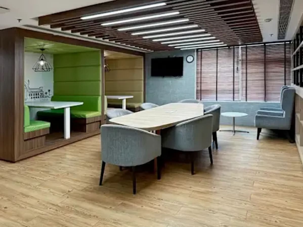 Modern coworking space in Lucknow featuring collaborative booths and a sleek conference table.