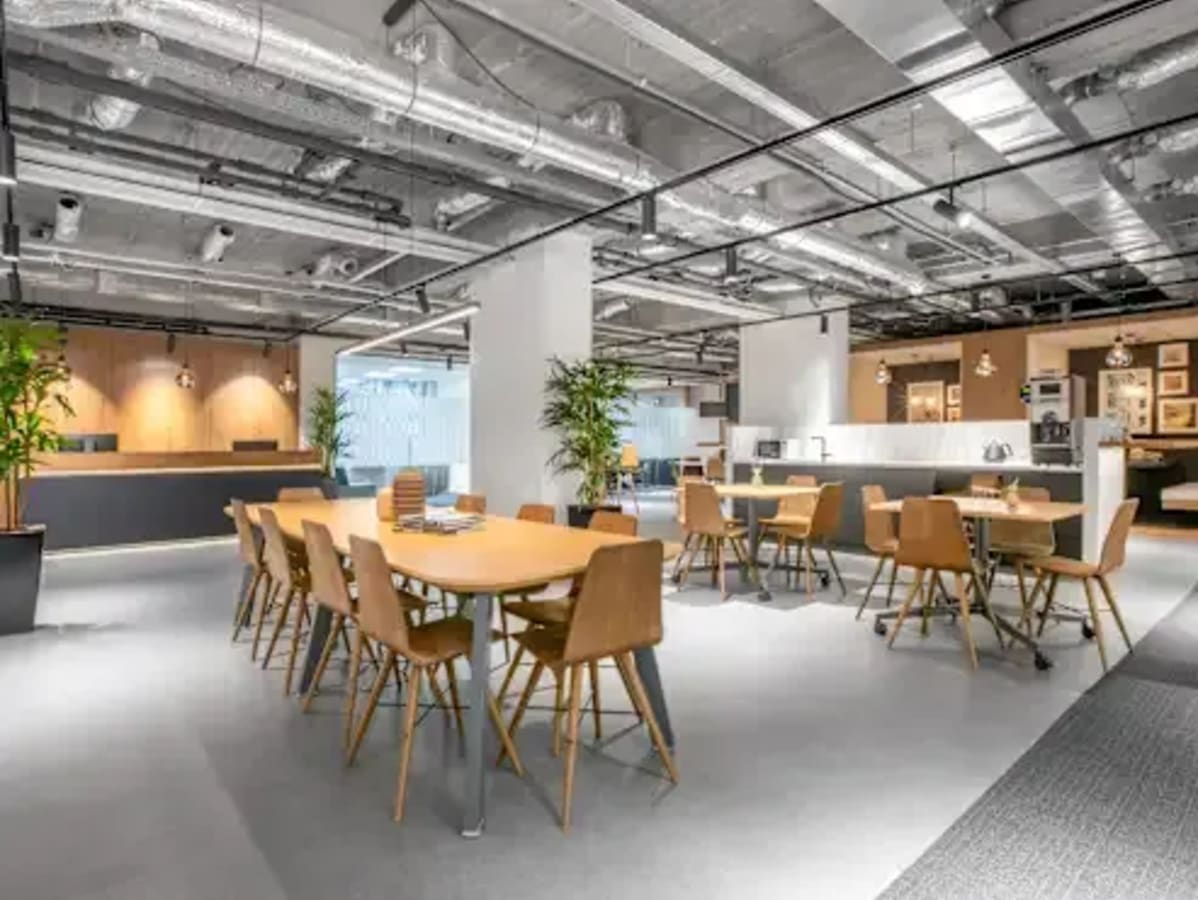 Modern coworking space with open seating, natural light, and contemporary decor in Kozhikode.