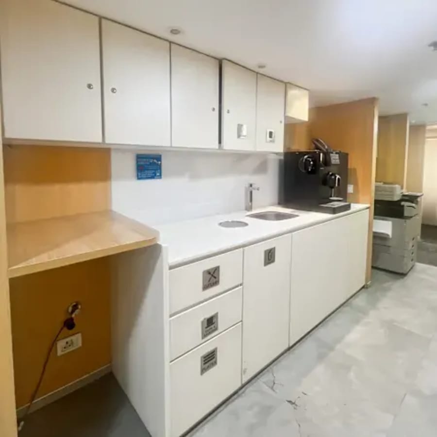 Sleek kitchenette in Nehru Place coworking space, featuring modern appliances and ample storage.