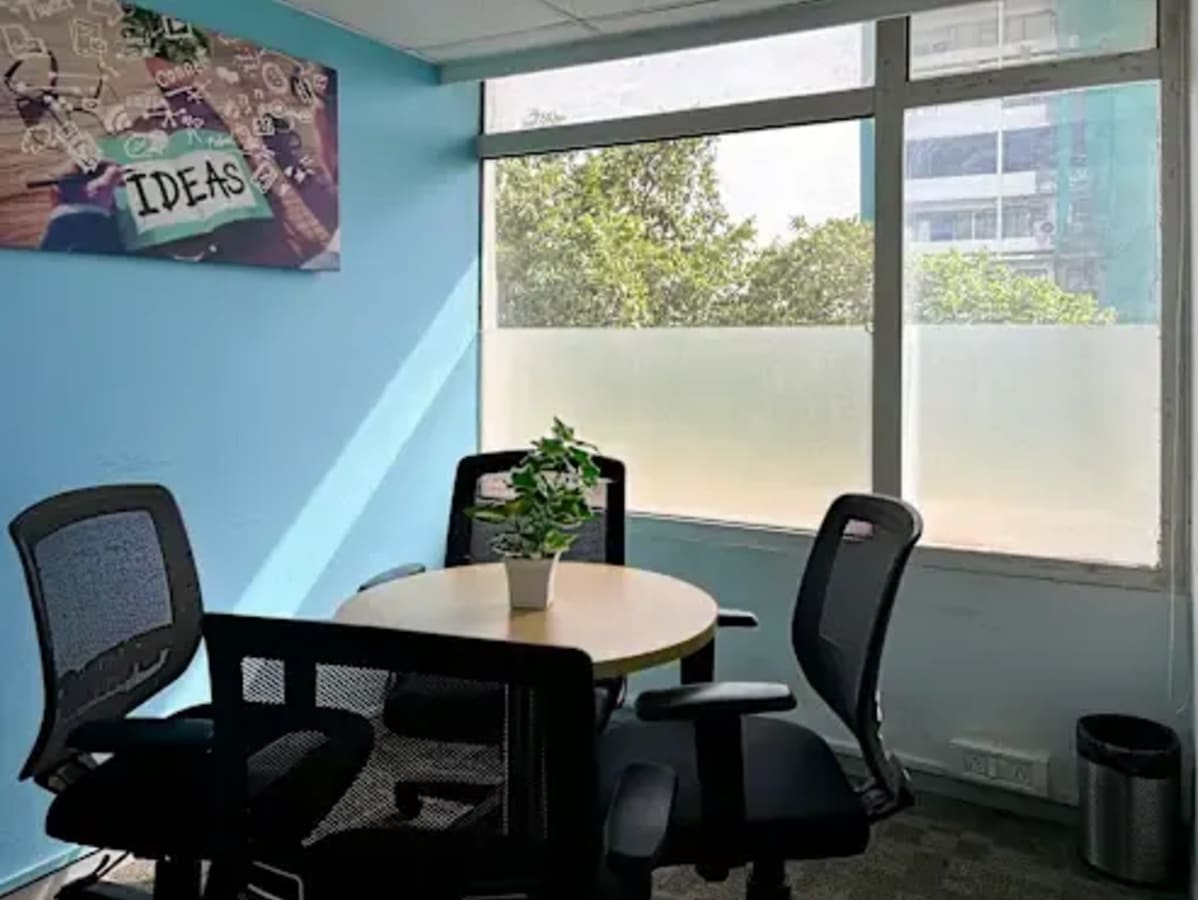 Bright coworking space with natural light, modern chairs, and a collaborative vibe.