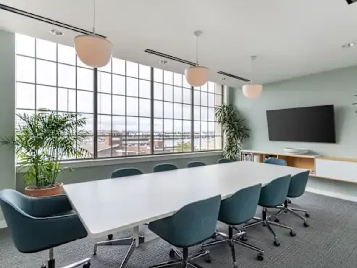 Bright meeting room with modern furnishings and large windows offering ample natural light.