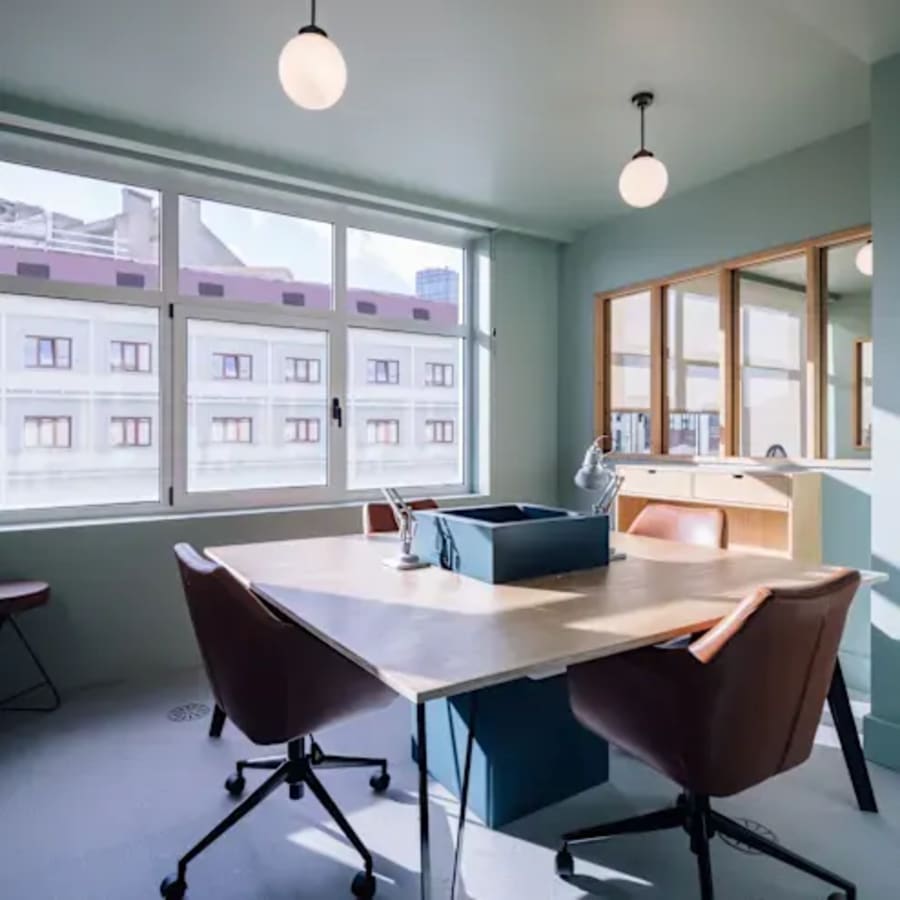 Bright coworking space with modern furniture and ample natural light, located in Juhu Tara Road.