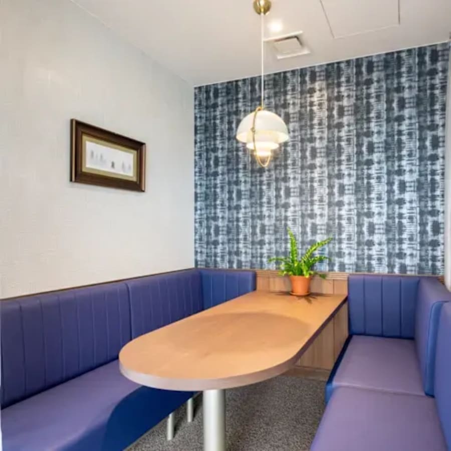 Cozy breakout area with plush seating and modern lighting, perfect for informal meetings.
