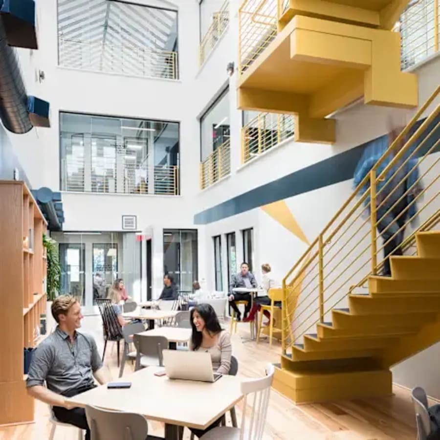 Bright, open coworking space with modern design, ample seating, and natural light. Perfect for collaboration.