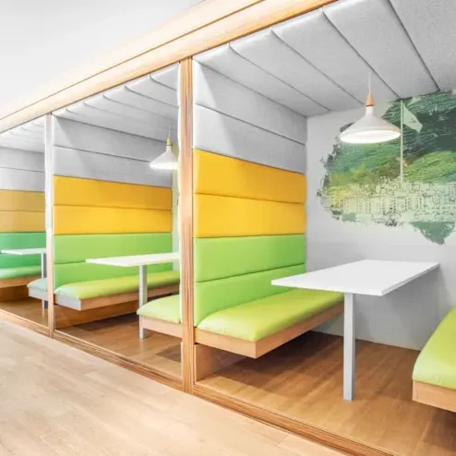 Vibrant, cushioned booths perfect for collaborative work at Cecil Street coworking space.