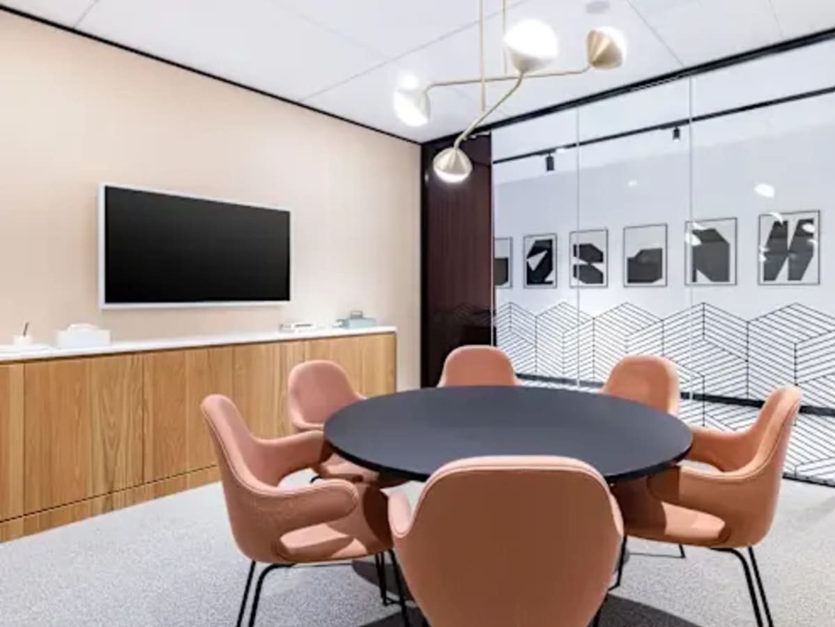 Stylish meeting room with modern decor and a sleek round table, perfect for collaborations.