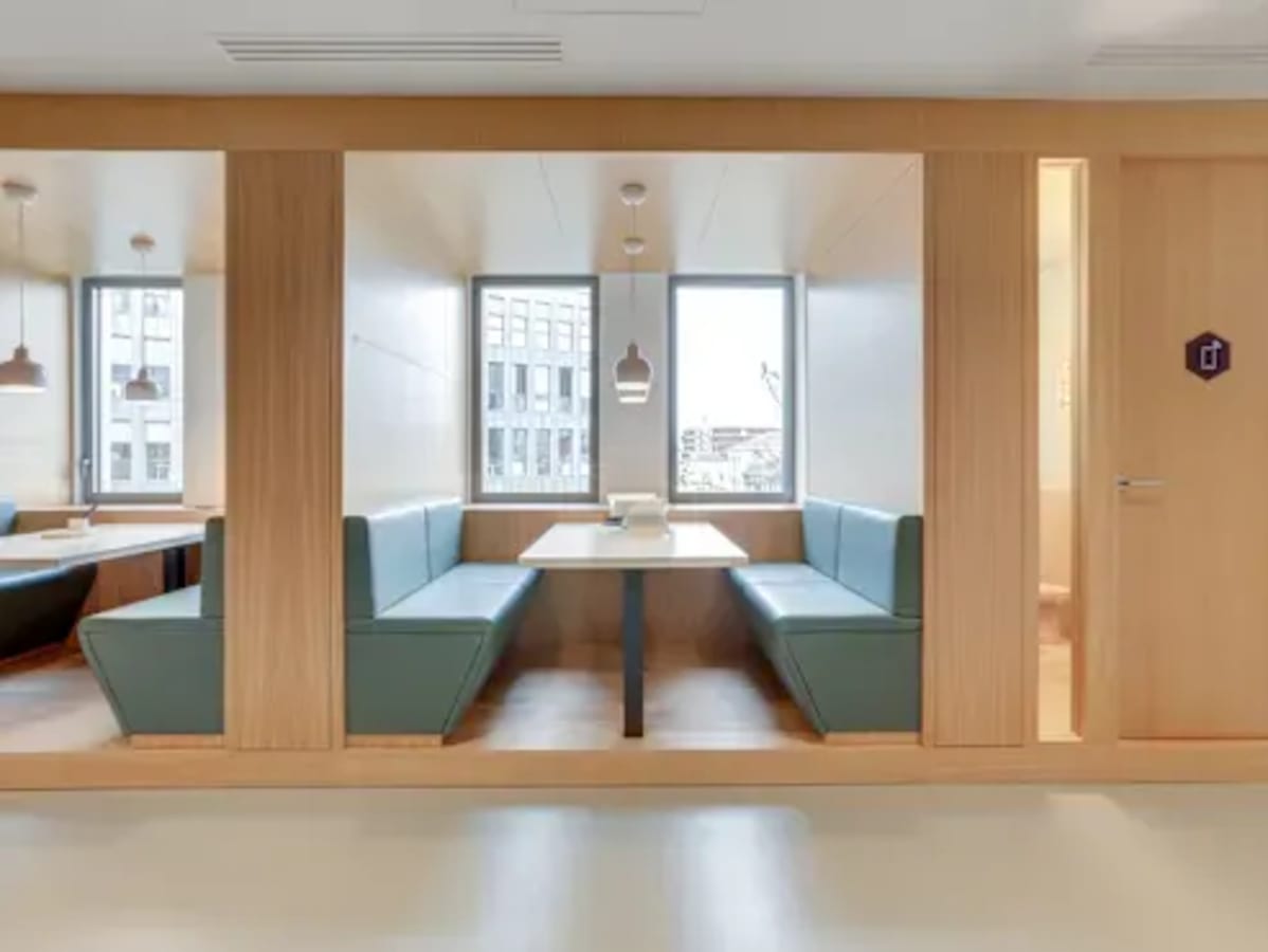 Modern coworking nook with ample natural light and cozy seating, ideal for collaboration.