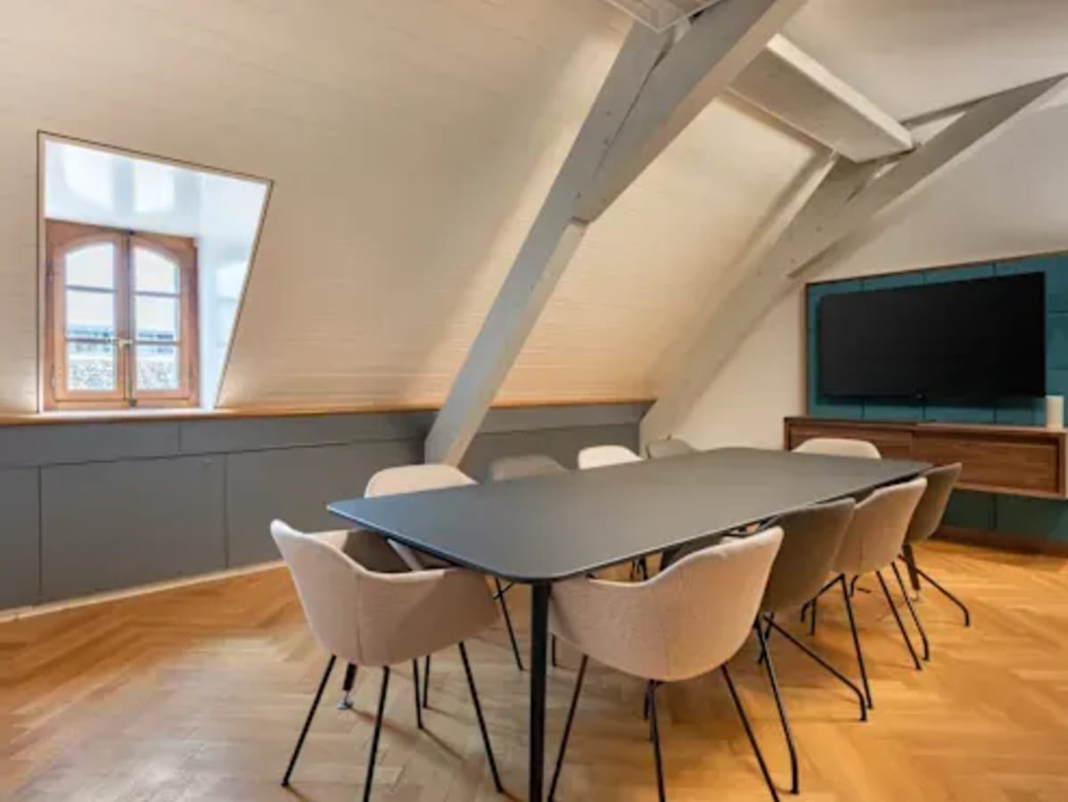 Modern coworking meeting room with sleek table, comfy chairs, and natural light in Lazer Street.