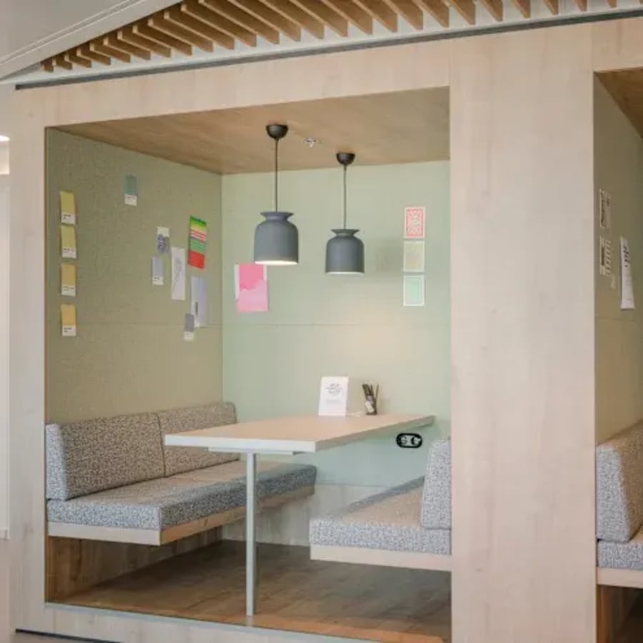 Modern coworking booth with cozy seating and ample lighting on Lazer Street. Perfect for collaboration.