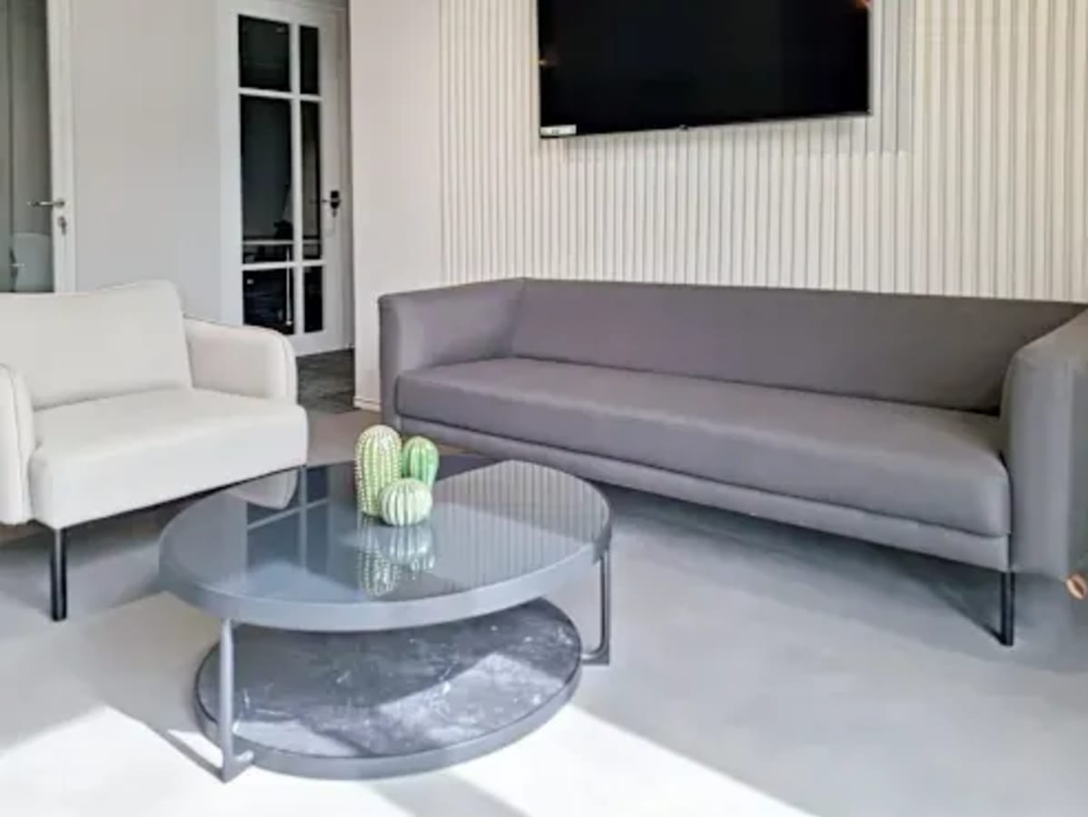 Stylish lounge area with modern seating and a sleek coffee table, perfect for a relaxed work session.
