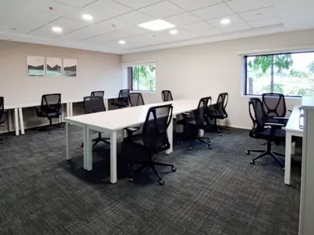 Flexible workspace with modern desks, ergonomic chairs, and natural light in Thudiyalur.