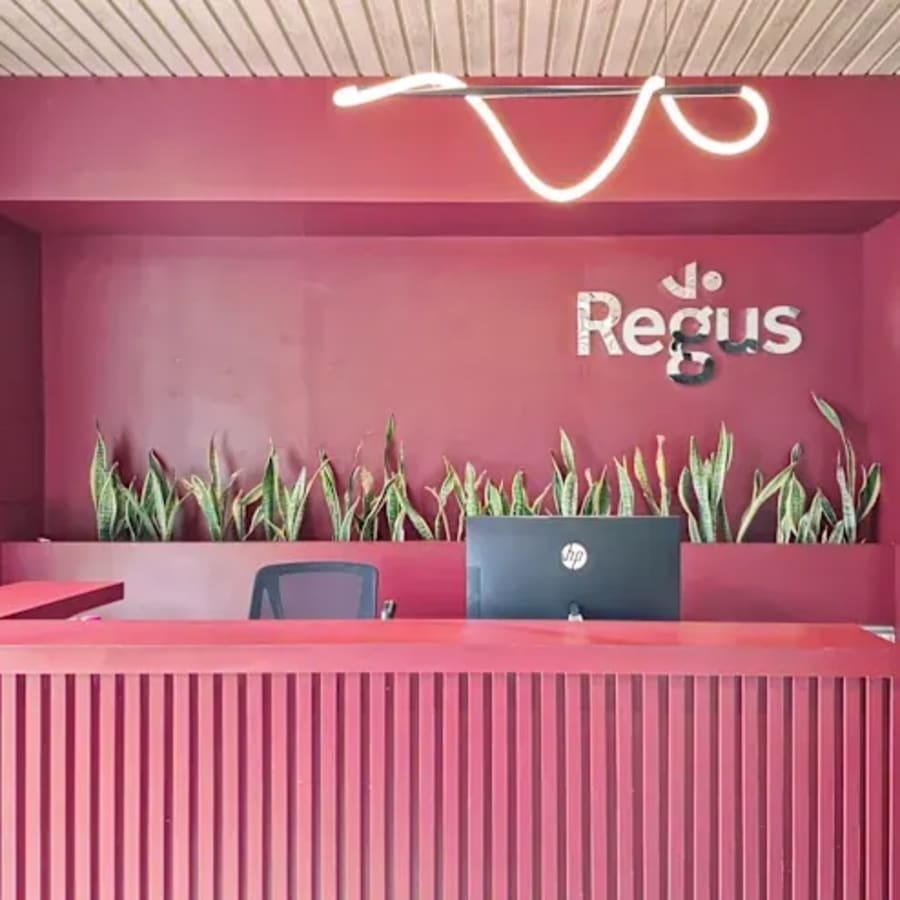 Modern reception area with bold red design and sleek lighting at a flexible coworking space.