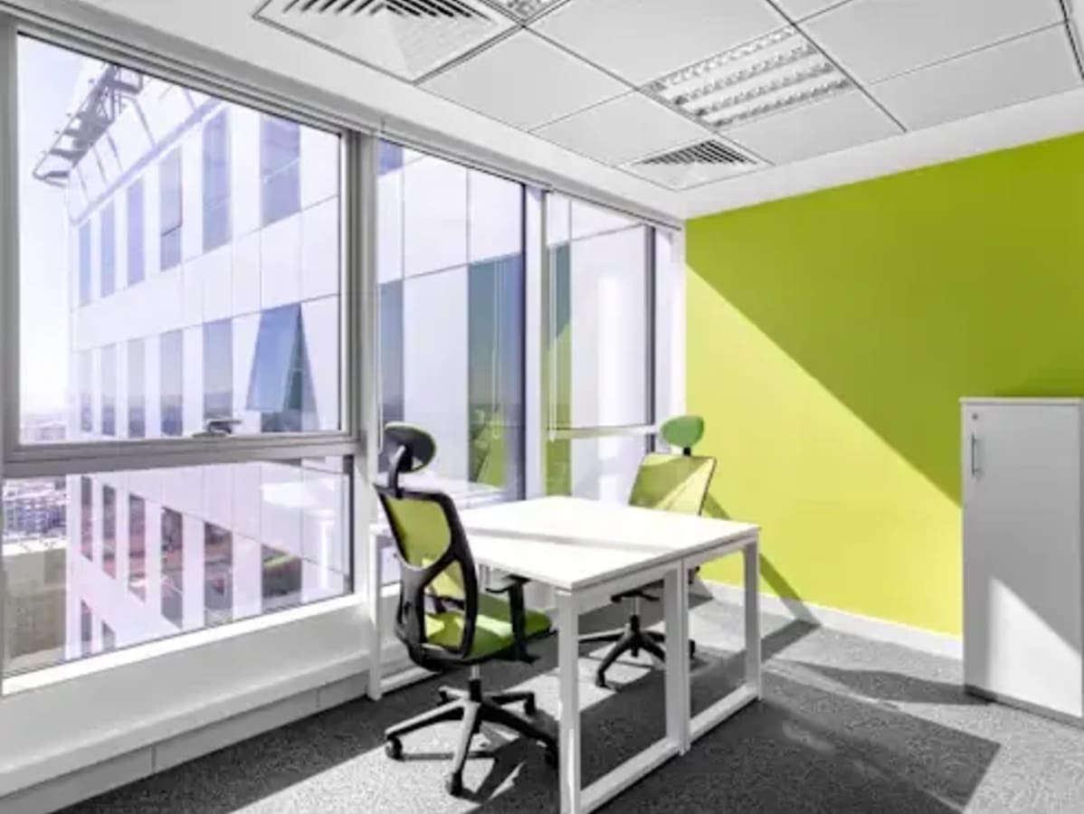 Bright coworking corner with modern furnishings and abundant natural light. Ideal for productivity.