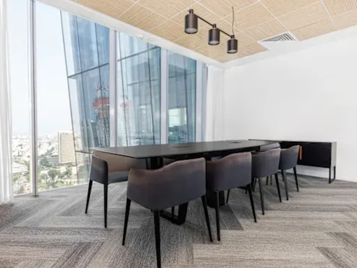 Bright, modern meeting room with city views and sleek design, ideal for collaboration.