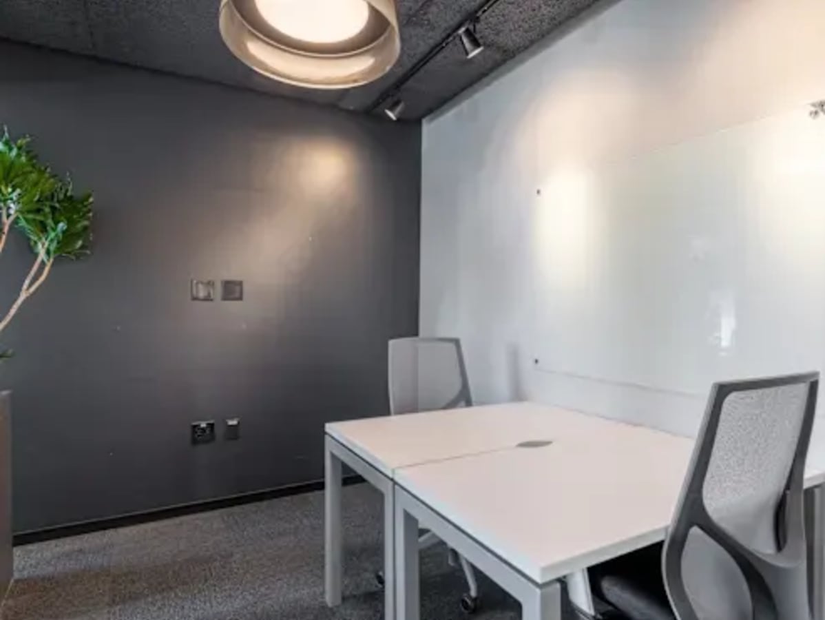 Modern coworking space in New Sneh Nagar with sleek desks, ergonomic chairs, and ample lighting.