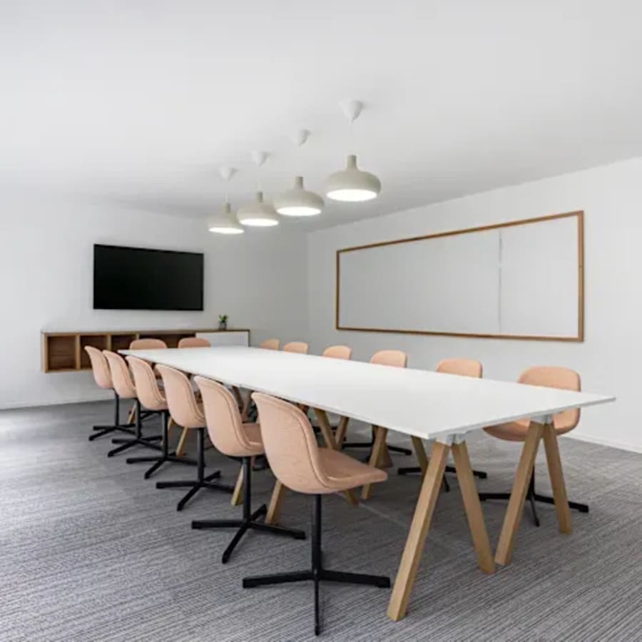 Sleek conference room in Wardha Road coworking space, featuring modern lighting and ample seating.