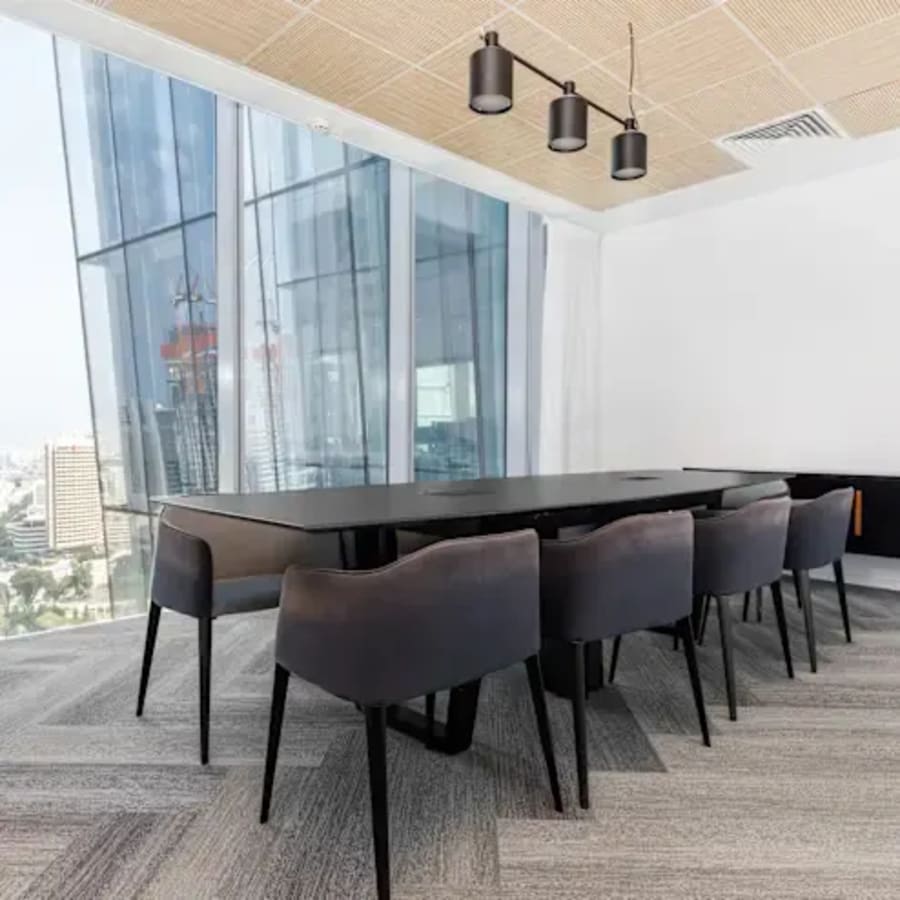 Contemporary meeting room with sleek furnishings and expansive city views. Ideal for collaboration.