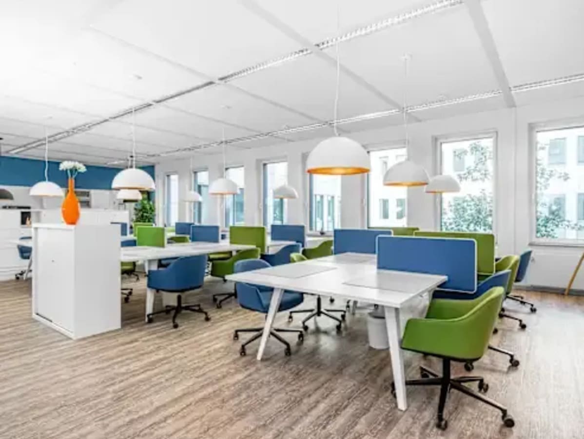 Bright, modern coworking space with vibrant seating and ample natural light.