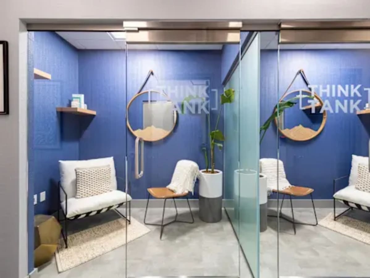 Sleek, modern coworking space in Navi Mumbai with cozy seating and stylish decor.