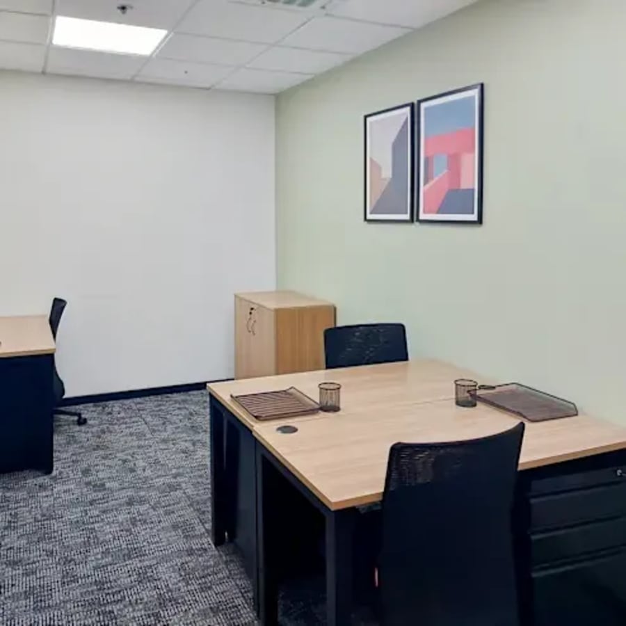 Modern coworking space with sleek desks, ample lighting, and tasteful decor in Powai.