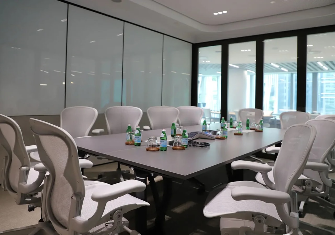 Modern conference room with ergonomic chairs and ample natural light in a prime coworking space.