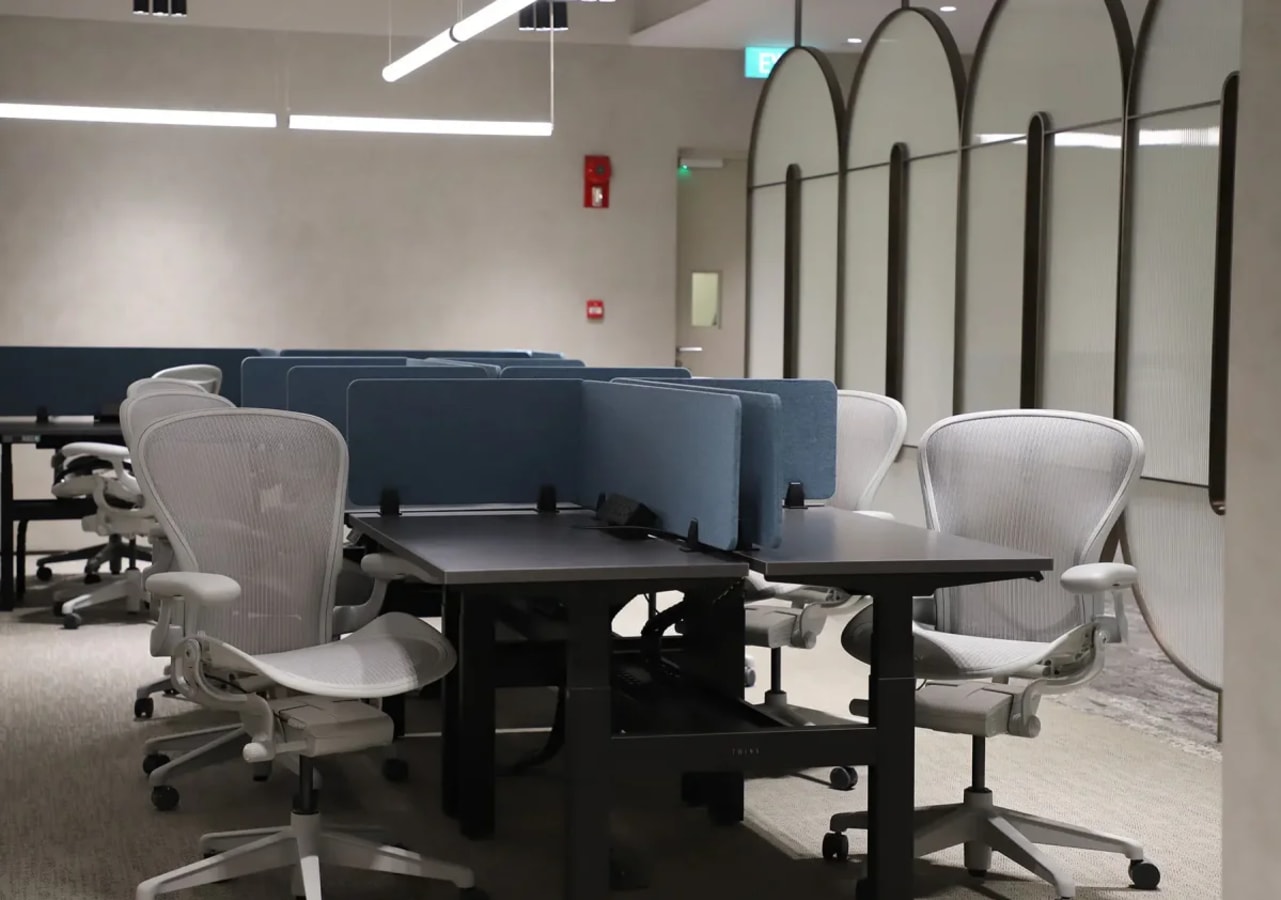 Modern coworking space with ergonomic chairs and partitioned desks on Church Street, Singapore.