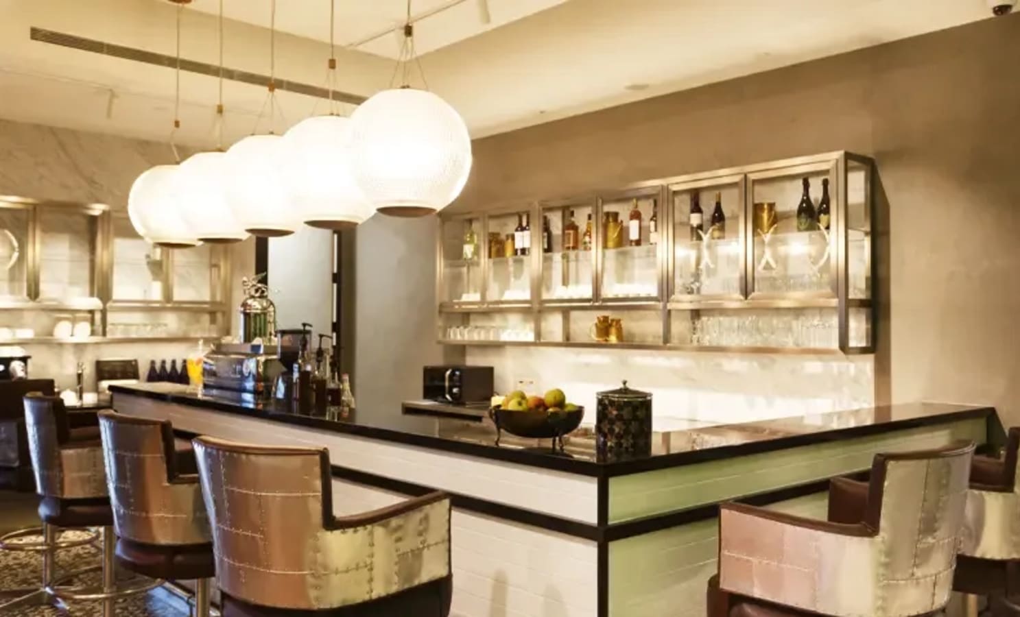 Chic coworking lounge with sleek bar seating and ambient lighting on Cecil Street, Singapore.