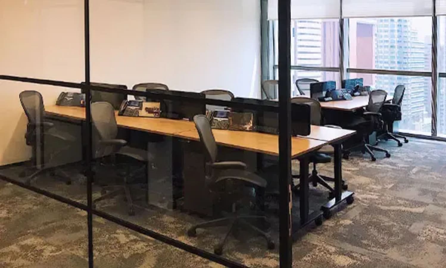 Spacious coworking area with ergonomic chairs and ample natural light. Ideal for collaboration.