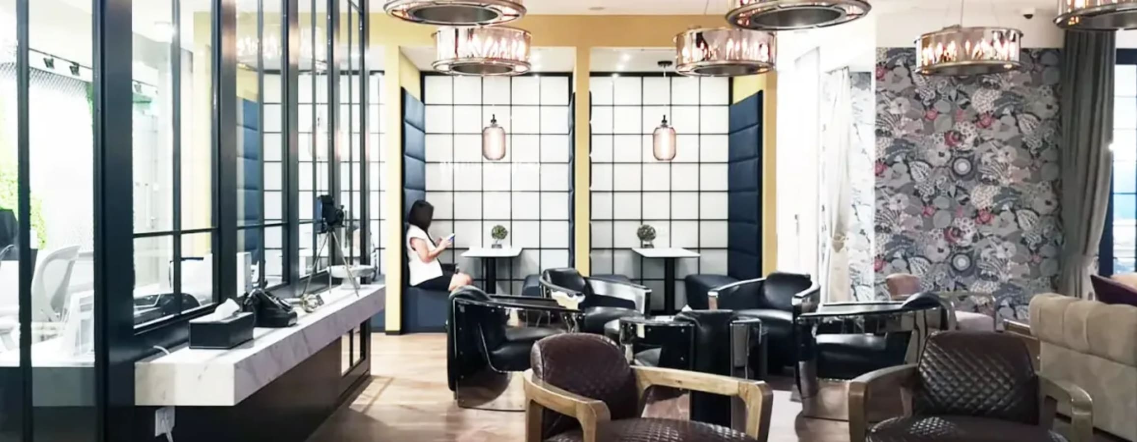 Stylish, modern coworking space with chic seating, vibrant accents, and ample natural light.