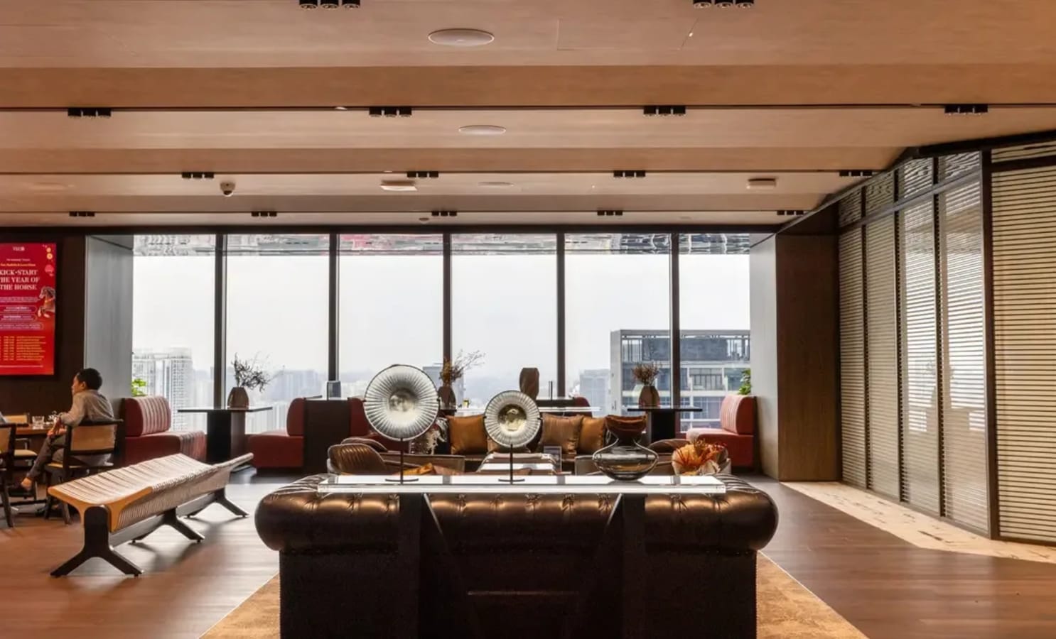 Modern coworking space with chic seating and expansive city views in Central Boulevard, Singapore.