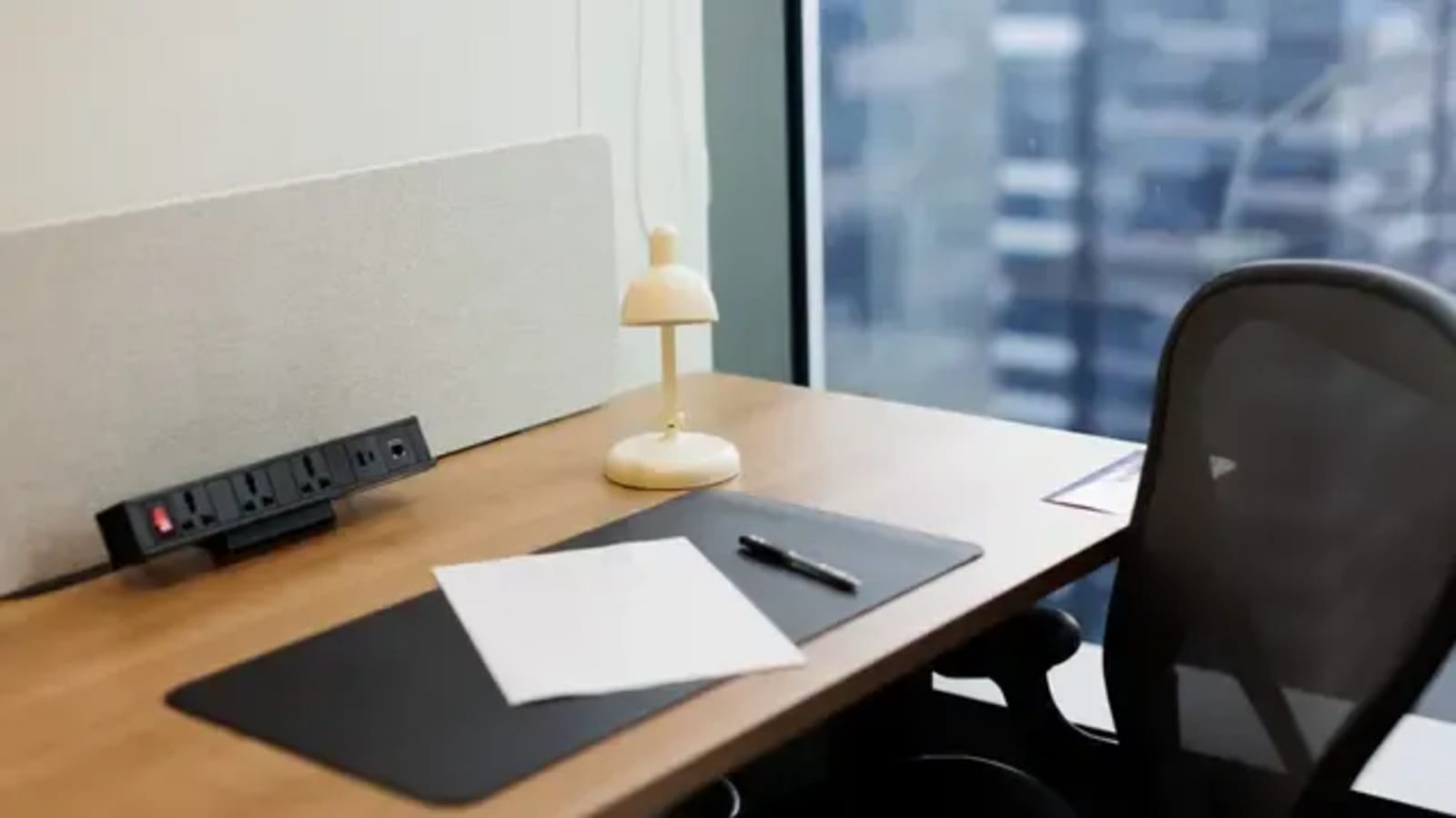Sleek, modern workspace with ergonomic chair and natural light. Ideal for productivity.
