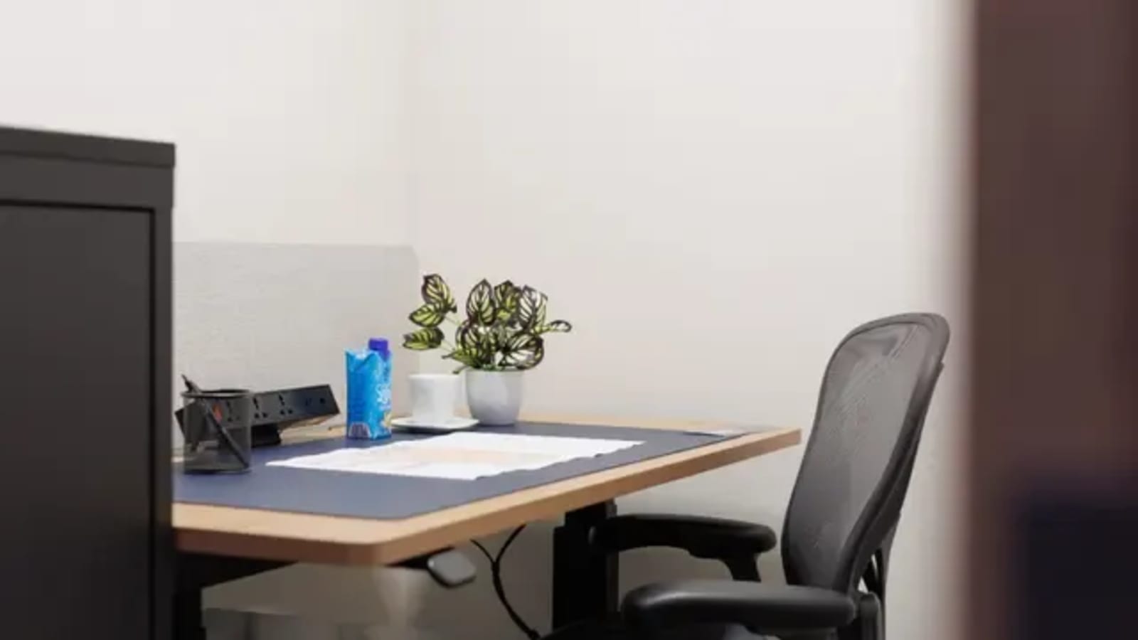 Modern coworking desk with ergonomic chair and natural light. Ideal for productivity.