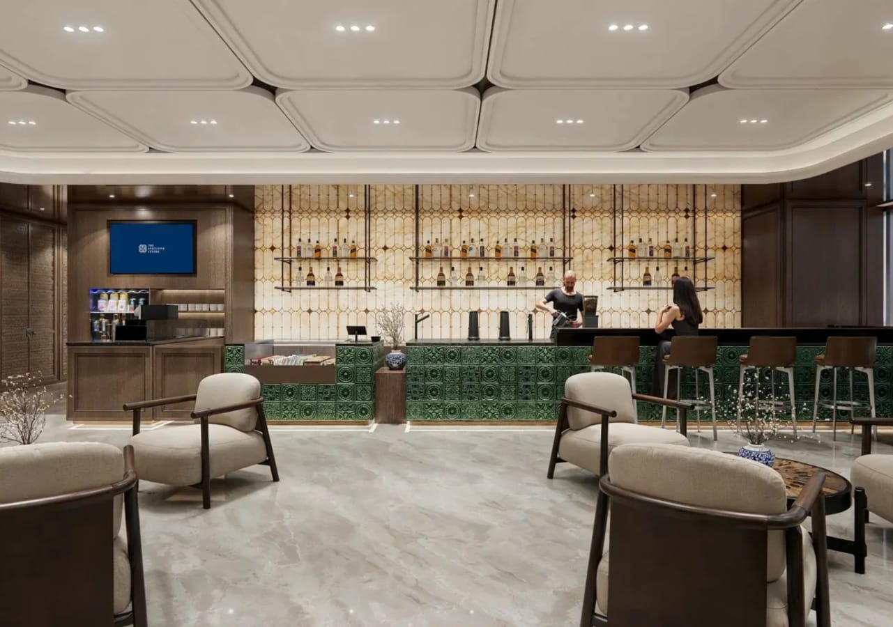 Chic coworking lounge with modern seating and a stylish bar in Central Boulevard, Singapore.