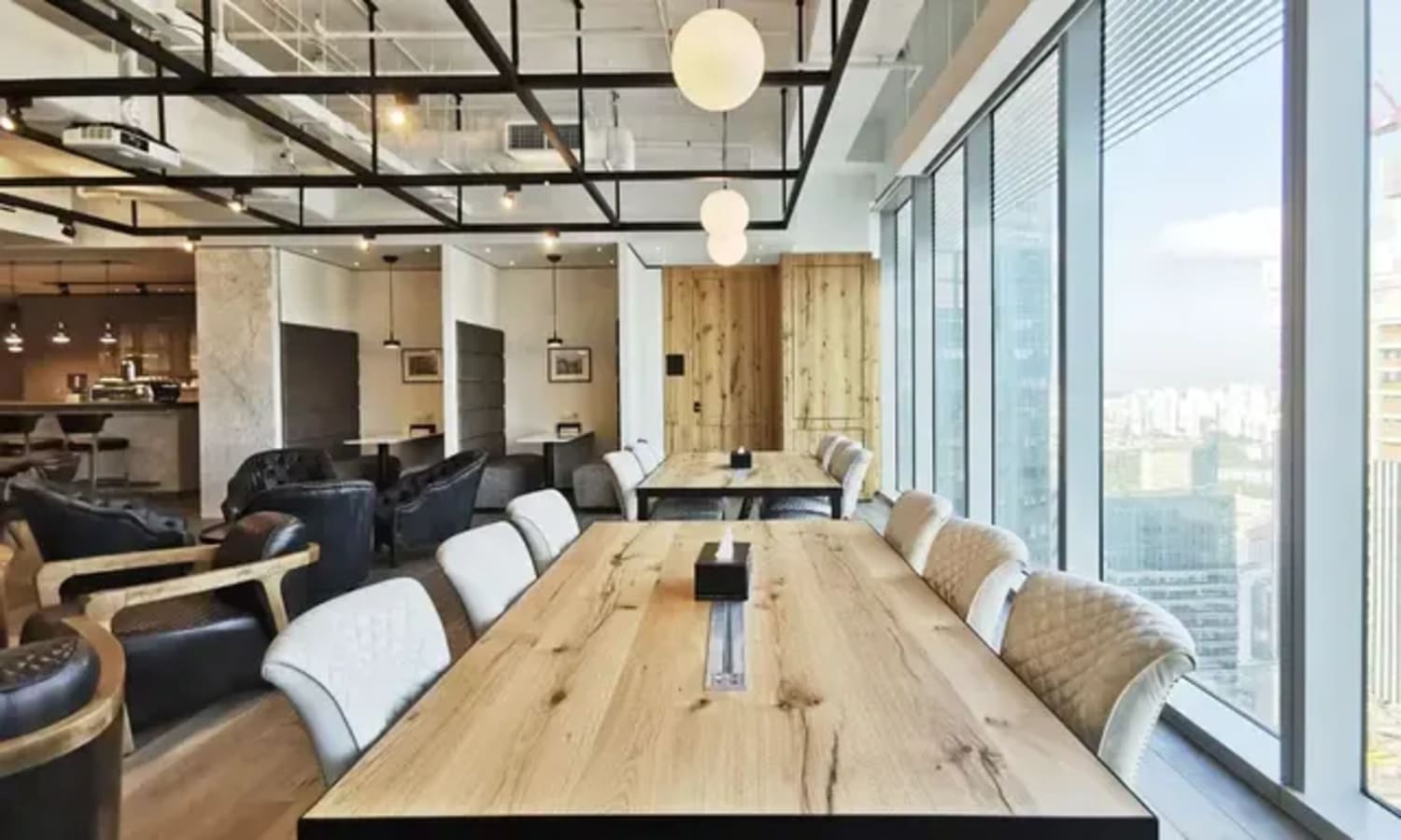 Modern coworking space with natural light, stylish seating, and city views. Perfect for collaboration.